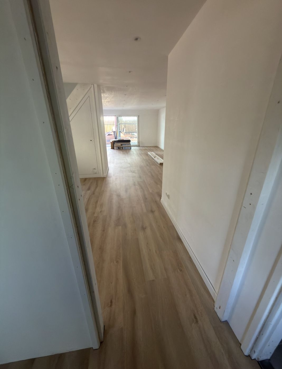 Gang met doorlopende PVC-vloer naar de woonkamer